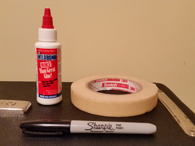 WELDBOND Glue, masking tape, and Sharpie pen.