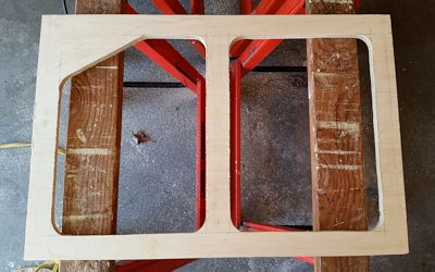 Plywood frame with openings cut in.