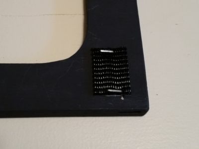 Velcro on the back of frame.